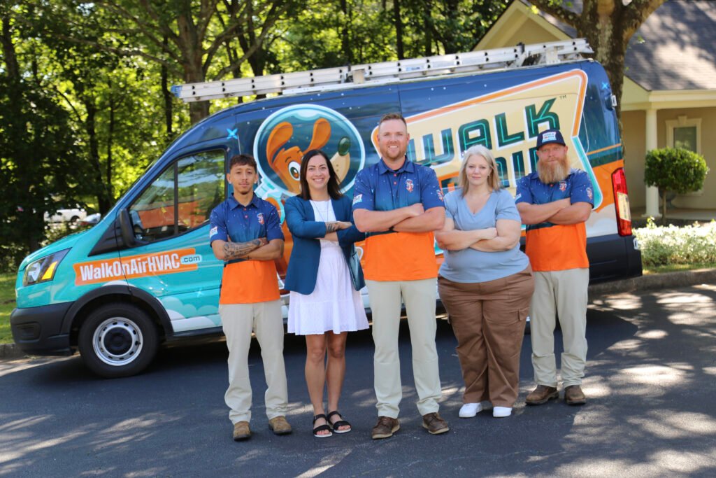 The Walk On Air Team standing in front of the Walk On Air HVAC truck with their arms crossed